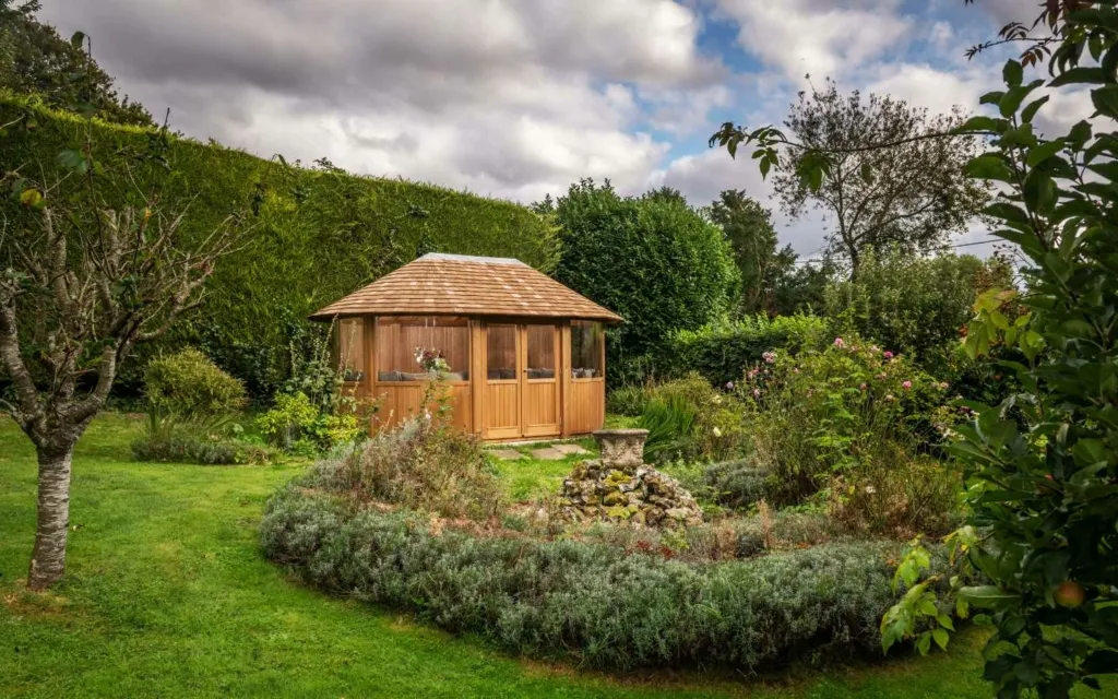 Garden room surrounded by trees and plants