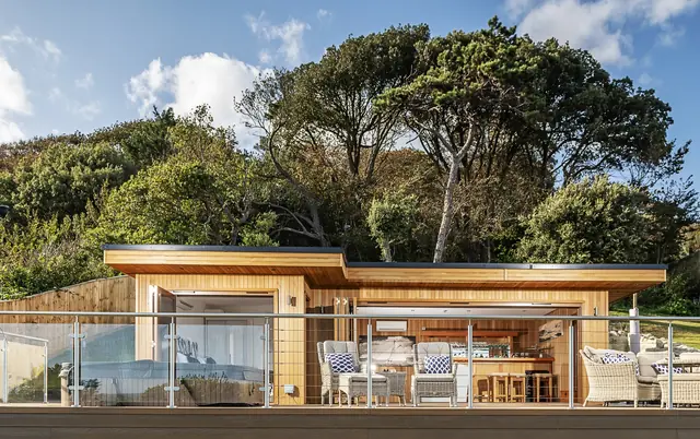 Crown timber garden room with a furnished terrace by the coast