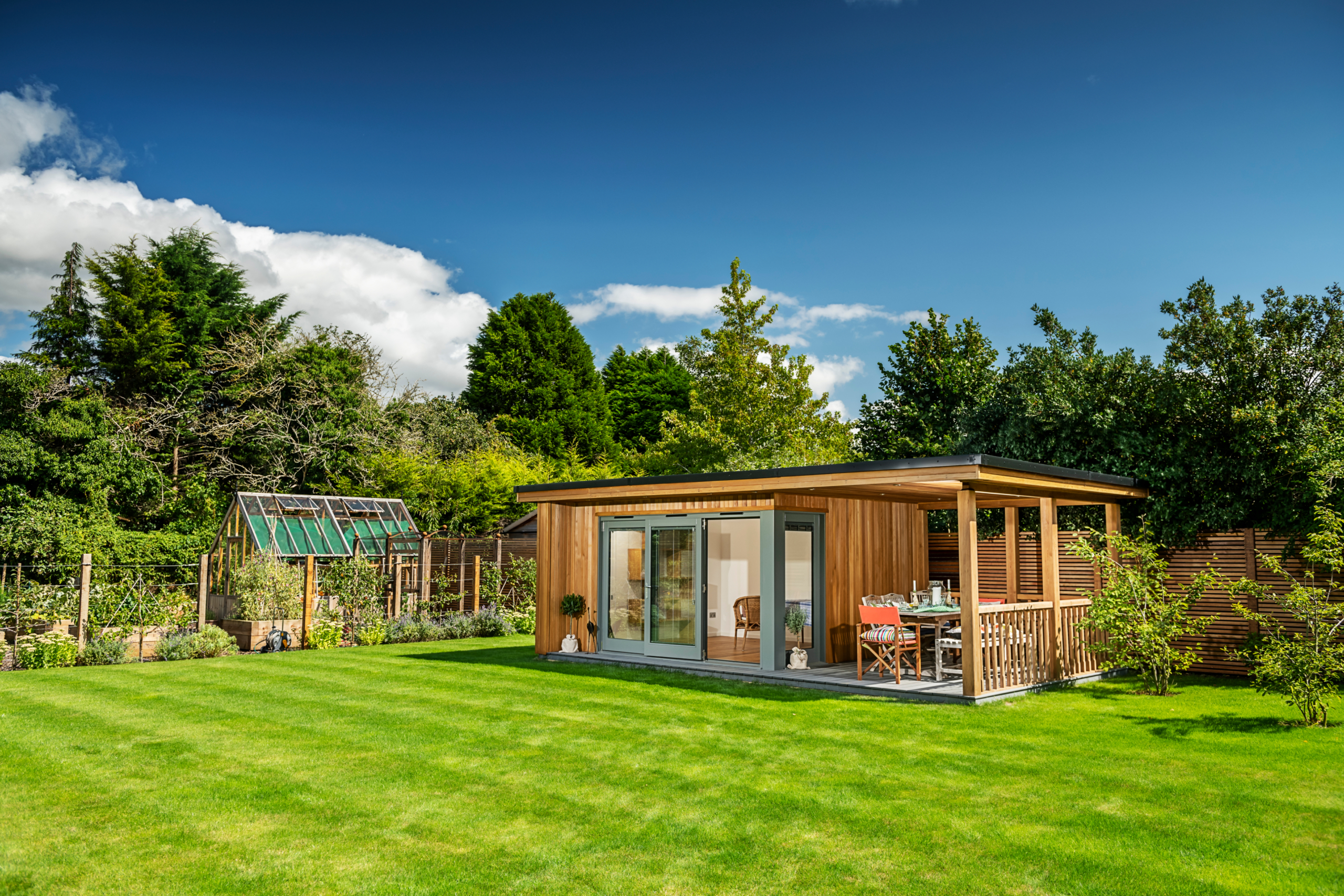 Garden room with outdoor seating near green house
